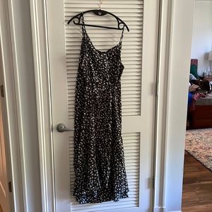 Black sun dress w/white flowers and buttons down the front. Tie waist.